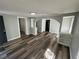 Spacious living room with wood floors, archways, and built in shelving at 2107 Hollywood Ave, Eustis, FL 32726