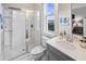 Well-lit bathroom featuring a glass shower and vanity with modern fixtures at 2320 Salty Winds Way, Kissimmee, FL 34747