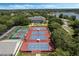Aerial view of tennis and pickleball courts and a clubhouse, complemented by lush greenery and well-maintained landscaping at 25105 Laurel Valley Rd, Leesburg, FL 34748