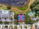This aerial view showcases the community amenities, including a pool and tennis courts near a pond at 25105 Laurel Valley Rd, Leesburg, FL 34748