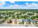 A high-angle view of a community with manicured lawns, mature trees, and a distant green expanse at 25105 Laurel Valley Rd, Leesburg, FL 34748