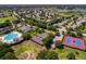 A beautiful aerial view featuring a pool, tennis courts, and lush landscaping of the community at 25105 Laurel Valley Rd, Leesburg, FL 34748