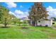 Large backyard features mature trees and a screened lanai offering a tranquil outdoor setting at 25105 Laurel Valley Rd, Leesburg, FL 34748