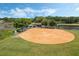 Aerial view of the baseball field near a pond, perfect for sports and recreation within the community at 25105 Laurel Valley Rd, Leesburg, FL 34748