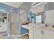 Modern bathroom with a glass shower, white vanities, and neutral tones at 25105 Laurel Valley Rd, Leesburg, FL 34748