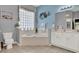 Bright bathroom featuring a soaking tub, double vanity, and tile flooring at 25105 Laurel Valley Rd, Leesburg, FL 34748