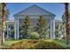 Elegant clubhouse featuring a grand entrance with stately columns and beautiful landscaping at 25105 Laurel Valley Rd, Leesburg, FL 34748