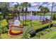 A beautifully landscaped entrance to the Plantation Golf and Country Club featuring colorful flower beds and a pond with a fountain at 25105 Laurel Valley Rd, Leesburg, FL 34748