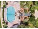 Overhead aerial view of community pool and outdoor lounging, featuring a stream and hot tub at 25105 Laurel Valley Rd, Leesburg, FL 34748