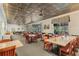 Well-lit dining area with tables, chairs, and decorative ceiling tiles provides an elegant space for restaurant patrons at 25105 Laurel Valley Rd, Leesburg, FL 34748