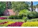 The Plantation at Leesburg entrance sign is beautifully landscaped with colorful flowers and greenery at 25105 Laurel Valley Rd, Leesburg, FL 34748