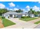 Attractive home showcasing a brick driveway, manicured lawn, and a covered front porch at 25105 Laurel Valley Rd, Leesburg, FL 34748