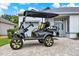 Custom black and yellow golf cart parked in front of a well-maintained home at 25105 Laurel Valley Rd, Leesburg, FL 34748