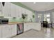 Well-lit kitchen with white cabinetry, stainless steel appliances, and view of the dining area at 25105 Laurel Valley Rd, Leesburg, FL 34748