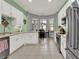 Spacious kitchen with white cabinets, modern appliances, and view of breakfast nook at 25105 Laurel Valley Rd, Leesburg, FL 34748