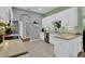 Bright kitchen with white cabinets, stainless steel appliances, and tile flooring at 25105 Laurel Valley Rd, Leesburg, FL 34748