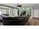Inviting living room featuring modern archways, dark wood floors, and a comfortable leather couch at 25105 Laurel Valley Rd, Leesburg, FL 34748