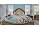 Well-lit main bedroom with a coastal theme, decorative lamps, and bedside tables at 25105 Laurel Valley Rd, Leesburg, FL 34748