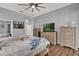 Spacious main bedroom with wood floors, furniture, and natural light at 25105 Laurel Valley Rd, Leesburg, FL 34748