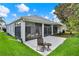 A screened lanai with a patio and chair provides a relaxing outdoor space at 25105 Laurel Valley Rd, Leesburg, FL 34748