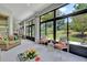 Bright sunroom with large windows overlooking the yard, furniture and a ceiling fan at 25105 Laurel Valley Rd, Leesburg, FL 34748
