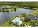 Aerial view of community pool, lake and manicured lawns, offering a resort-style living experience at 3363 Morelyn Crest Cir, Orlando, FL 32828