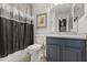 Neutral bathroom featuring a modern vanity, toilet, and shower with decorative curtain at 3363 Morelyn Crest Cir, Orlando, FL 32828