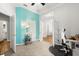 Bright bedroom features an accent wall, a door, and French doors to other parts of the home at 3363 Morelyn Crest Cir, Orlando, FL 32828
