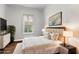 Inviting bedroom showcases a comfortable bed with decorative pillows, a sleek dresser, and bright natural light at 3363 Morelyn Crest Cir, Orlando, FL 32828