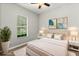 Comfortable bedroom featuring a plush bed, stylish décor, and a window providing natural light and a relaxing ambiance at 3363 Morelyn Crest Cir, Orlando, FL 32828