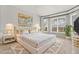 Luxurious bedroom featuring a large white bed, gold accents, bedside tables, and a bright window at 3363 Morelyn Crest Cir, Orlando, FL 32828