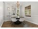 Bright dining room with a modern chandelier, large window, and seating for six at 3363 Morelyn Crest Cir, Orlando, FL 32828
