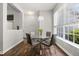 Stylish dining area with a glass table, seating for four, and a window that offers plenty of natural light at 3363 Morelyn Crest Cir, Orlando, FL 32828