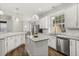 Kitchen featuring wood floors, pendant lights, white cabinets, and stainless steel appliances at 3363 Morelyn Crest Cir, Orlando, FL 32828