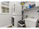 Laundry room features a stacked washer and dryer, a window and plenty of storage at 3363 Morelyn Crest Cir, Orlando, FL 32828