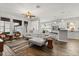Bright living area featuring a corner sofa, hardwood floors, and an open layout connecting to the kitchen and dining spaces at 3363 Morelyn Crest Cir, Orlando, FL 32828