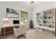 Bright home office with white desk, built-in bookshelves, and a comfortable chair provides an ideal workspace at 3363 Morelyn Crest Cir, Orlando, FL 32828