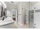 Bright bathroom with double sinks, walk-in glass shower, and access to the bedroom at 3618 Pompano Ct, Gotha, FL 34734
