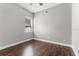 A simply designed empty bedroom featuring hardwood floors, a window, and neutral walls at 3618 Pompano Ct, Gotha, FL 34734