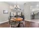 Charming dining space with hardwood floors and chandelier open to the living room, kitchen, and bedroom areas at 3618 Pompano Ct, Gotha, FL 34734