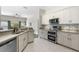 Open-concept kitchen with stainless steel appliances, modern cabinetry, and granite countertops at 3618 Pompano Ct, Gotha, FL 34734