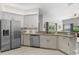 Stylish kitchen with stainless steel appliances and bright cabinets at 3618 Pompano Ct, Gotha, FL 34734