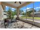 Cozy screened lanai with brick flooring, ceiling fan, and comfortable seating overlooking the backyard at 3618 Pompano Ct, Gotha, FL 34734