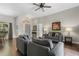 Open-concept living room showcases hardwood floors, neutral paint, and ample seating with a view to the dining area at 3618 Pompano Ct, Gotha, FL 34734
