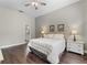 Relaxing main bedroom featuring hardwood floors and neutral paint with access to the en suite bathroom at 3618 Pompano Ct, Gotha, FL 34734