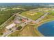 Aerial view showcasing baseball fields, tennis courts, and a serene lake, highlighting a comprehensive recreational area at 3994 Knott Dr, Apopka, FL 32712