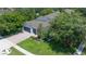 Beautiful aerial view of a home with a three-car garage, lush landscaping, and a charming brick driveway in a quiet neighborhood at 3994 Knott Dr, Apopka, FL 32712