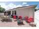 Backyard patio area with a dining set, lounge seating, and a fire pit at 3994 Knott Dr, Apopka, FL 32712