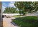 Expansive fenced backyard featuring green lawn, outdoor dining, and mature trees at 3994 Knott Dr, Apopka, FL 32712