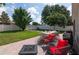 Backyard with patio featuring outdoor dining and seating areas with mature trees and green grass at 3994 Knott Dr, Apopka, FL 32712